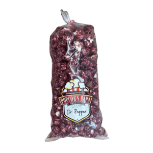 A bag of red grapes on a black background